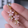 18 Karat Gold Plated hoop earrings with pink daisy pendants