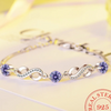 Thin 925 sterling silver infinity bracelet with beautiful coloured zirconia stones